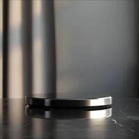 A black and silver circular object on a marble table photo