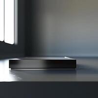 A black box sitting on a table in front of a window photo