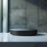 A black circular object on a table in front of a window photo