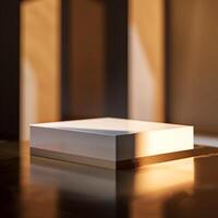 A white box sitting on a table in front of a window photo
