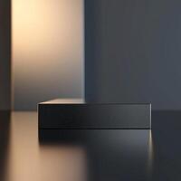 A black box sitting on a table in front of a wall photo