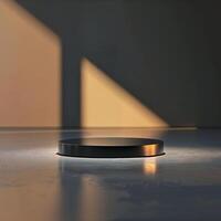 A black object sitting on a table in front of a wall photo