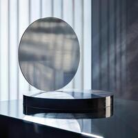 A mirror on a table with a window behind it photo
