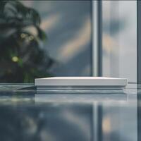 A white box sitting on a table in front of a window photo