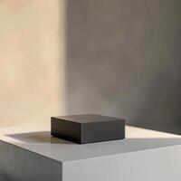A black square on top of a white table photo