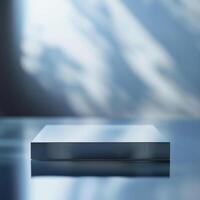 A silver box sitting on a table in front of a window photo