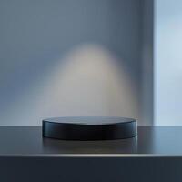 A black round object on a table in front of a window photo