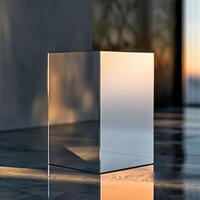 A glass cube sitting on a table in front of a window photo