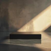 A black box sitting on a table in front of a wall photo