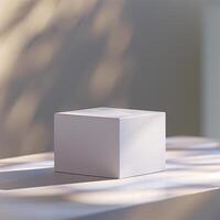 A white cube sitting on a table in front of a wall photo
