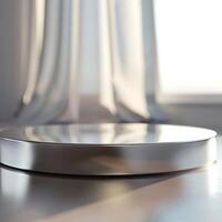 A silver plate on a table in front of a window photo