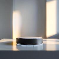 A smart speaker on a table in front of a window photo