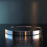 A round table with a silver surface on a dark surface photo