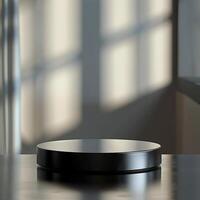 A black round table on a table in front of a window photo