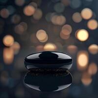 A black object sitting on a table with a light background photo