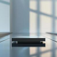 A black square on a table in front of a window photo