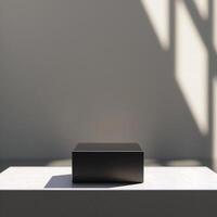 A black box sitting on a table in front of a wall photo