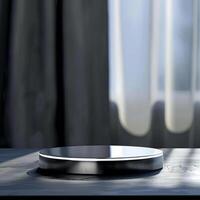 A small round object on a table in front of a window photo