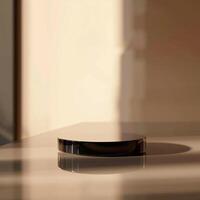 A black object sitting on a table in front of a window photo
