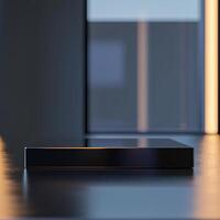 A black box sitting on a table in front of a window photo