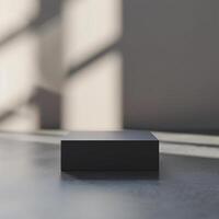 A black box sitting on a floor in front of a wall photo