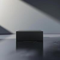 A black box sitting on a table in front of a wall photo