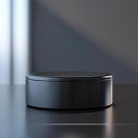 A black box sitting on a table with a light behind it photo