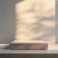 A white box sitting on a table in front of a window photo