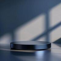 A black circular object on a table in front of a window photo