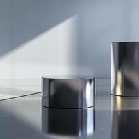 Two silver cylinders sitting on a shiny surface photo