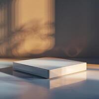 A white box sitting on a table in front of a window photo