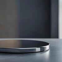 A circular black and silver device on a table photo