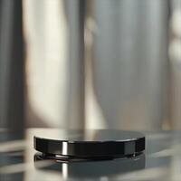 A black object on a table with a window in the background photo