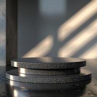 A stack of three black plates on a table photo