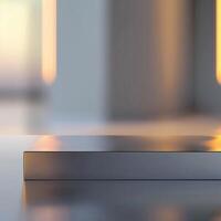 A silver box sitting on a table in front of a blurry background photo