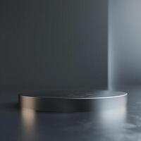 A round table with a silver surface on a dark floor photo