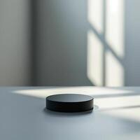 A black object sitting on a table in front of a window photo