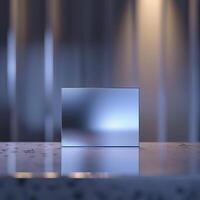 A silver box sitting on a table in front of a wall photo