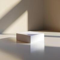 A white box sitting on a table in front of a window photo