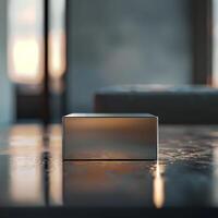 A square box sitting on a table in front of a window photo