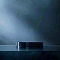 A black object sitting on a table in front of a dark background photo
