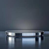 A round table with a silver surface on a dark background photo
