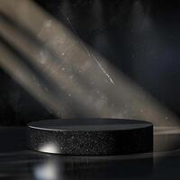 An empty black round table in front of a spotlight photo