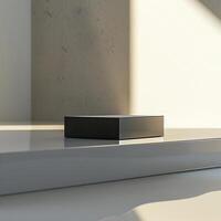 A black box sitting on a table in front of a wall photo