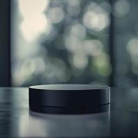 A black box sitting on a table in front of a window photo