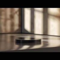 A black object sitting on a table in front of a window photo