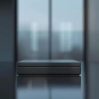 A black box sitting on a table in front of a window photo