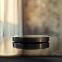 A black object sitting on a table in front of a window photo