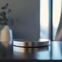 A silver object on a table in front of a window photo