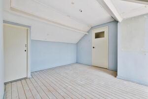An empty room with a door and a wooden floor photo